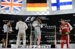 The podium (L to R): Nico Rosberg (GER) Mercedes AMG F1, race winner; Lewis Hamilton (GBR) Mercedes AMG F1, second; Kimi Raikkonen (FIN) Ferrari, third. 29.11.2015. Formula 1 World Championship, Rd 19, Abu Dhabi Grand Prix, Yas Marina Circuit, Abu Dhabi, Race Day.