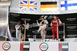 (L to R): Lewis Hamilton (GBR) Mercedes AMG F1 and race winner Nico Rosberg (GER) Mercedes AMG F1 celebrate on the podium with Kimi Raikkonen (FIN) Ferrari. 29.11.2015. Formula 1 World Championship, Rd 19, Abu Dhabi Grand Prix, Yas Marina Circuit, Abu Dhabi, Race Day.
