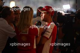 Sebastian Vettel (GER) Ferrari with the media. 28.11.2015. Formula 1 World Championship, Rd 19, Abu Dhabi Grand Prix, Yas Marina Circuit, Abu Dhabi, Qualifying Day.