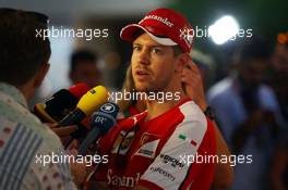 Sebastian Vettel (GER) Ferrari with the media. 28.11.2015. Formula 1 World Championship, Rd 19, Abu Dhabi Grand Prix, Yas Marina Circuit, Abu Dhabi, Qualifying Day.