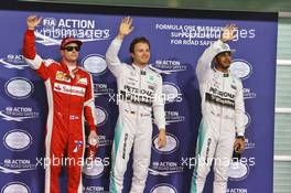 Qualifying top three in parc ferme (L to R): Kimi Raikkonen (FIN) Ferrari, third; Nico Rosberg (GER) Mercedes AMG F1, pole position; Lewis Hamilton (GBR) Mercedes AMG F1, second. 28.11.2015. Formula 1 World Championship, Rd 19, Abu Dhabi Grand Prix, Yas Marina Circuit, Abu Dhabi, Qualifying Day.