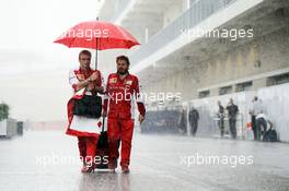 (L to R): Maurizio Arrivabene (ITA) Ferrari Team Principal with Gino Rosato (CDN) Ferrari in a wet and rainy paddock. 23.10.2015. Formula 1 World Championship, Rd 16, United States Grand Prix, Austin, Texas, USA, Practice Day.