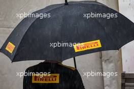 Pirelli umbrella in the heavy rain. 23.10.2015. Formula 1 World Championship, Rd 16, United States Grand Prix, Austin, Texas, USA, Practice Day.