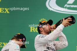 Race winner and World Champion Lewis Hamilton (GBR) Mercedes AMG F1 celebrates on the podium with with Nico Rosberg (GER) Mercedes AMG F1. 25.10.2015. Formula 1 World Championship, Rd 16, United States Grand Prix, Austin, Texas, USA, Race Day.