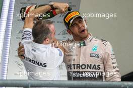 Race winner and World Champion Lewis Hamilton (GBR) Mercedes AMG F1 celebrates on the podium with Paddy Lowe (GBR) Mercedes AMG F1 Executive Director (Technical). 25.10.2015. Formula 1 World Championship, Rd 16, United States Grand Prix, Austin, Texas, USA, Race Day.