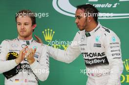 Race winner and World Champion Lewis Hamilton (GBR) Mercedes AMG F1 celebrates on the podium with team mate Nico Rosberg (GER) Mercedes AMG F1 (Left). 25.10.2015. Formula 1 World Championship, Rd 16, United States Grand Prix, Austin, Texas, USA, Race Day.