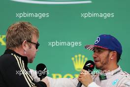 The podium (L to R): Sir Elton John (GBR) with race winner and World Champion Lewis Hamilton (GBR) Mercedes AMG F1 on the podium. 25.10.2015. Formula 1 World Championship, Rd 16, United States Grand Prix, Austin, Texas, USA, Race Day.