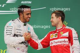 (L to R): Race winner and World Champion Lewis Hamilton (GBR) Mercedes AMG F1 celebrates on the podium with third placed Sebastian Vettel (GER) Ferrari. 25.10.2015. Formula 1 World Championship, Rd 16, United States Grand Prix, Austin, Texas, USA, Race Day.