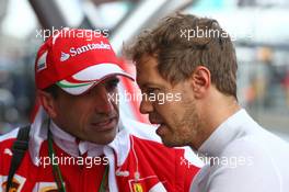 (L to R): Marc Gene (ESP) Ferrari Test Driver with Sebastian Vettel (GER) Ferrari. 18.03.2016. Formula 1 World Championship, Rd 1, Australian Grand Prix, Albert Park, Melbourne, Australia, Practice Day.