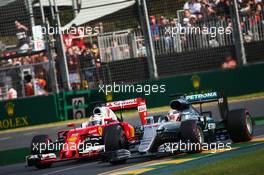 Lewis Hamilton (GBR) Mercedes AMG F1 W07 Hybrid and Sebastian Vettel (GER) Ferrari SF16-H battle for position. 20.03.2016. Formula 1 World Championship, Rd 1, Australian Grand Prix, Albert Park, Melbourne, Australia, Race Day.