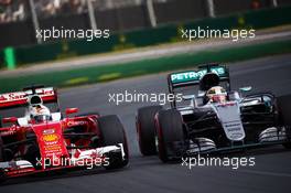 Lewis Hamilton (GBR) Mercedes AMG F1 W07 Hybrid and Sebastian Vettel (GER) Ferrari SF16-H battle for position. 20.03.2016. Formula 1 World Championship, Rd 1, Australian Grand Prix, Albert Park, Melbourne, Australia, Race Day.