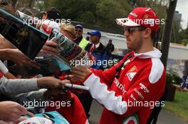 Sebastian Vettel (GER) Ferrari signs autographs for the fans. 19.03.2016. Formula 1 World Championship, Rd 1, Australian Grand Prix, Albert Park, Melbourne, Australia, Qualifying Day.