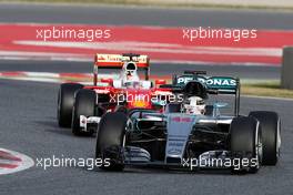 Lewis Hamilton (GBR) Mercedes AMG F1 W07 Hybrid leads Sebastian Vettel (GER)  Ferrari SF16-H. 22.02.2016. Formula One Testing, Day One, Barcelona, Spain. Monday.