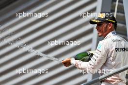 Lewis Hamilton (GBR) Mercedes AMG F1 celebrates his third position with the champagne on the podium. 28.08.2016. Formula 1 World Championship, Rd 13, Belgian Grand Prix, Spa Francorchamps, Belgium, Race Day.