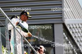 Lewis Hamilton (GBR) Mercedes AMG F1 celebrates his third position with the champagne on the podium. 28.08.2016. Formula 1 World Championship, Rd 13, Belgian Grand Prix, Spa Francorchamps, Belgium, Race Day.