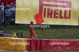 A marshal waves a red flag as the race is stoppd. 28.08.2016. Formula 1 World Championship, Rd 13, Belgian Grand Prix, Spa Francorchamps, Belgium, Race Day.