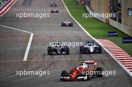 Lewis Hamilton (GBR) Mercedes AMG F1 W07 Hybrid and Valtteri Bottas (FIN) Williams FW38 battle for position behind Kimi Raikkonen (FIN) Ferrari SF16-H. 03.04.2016. Formula 1 World Championship, Rd 2, Bahrain Grand Prix, Sakhir, Bahrain, Race Day.