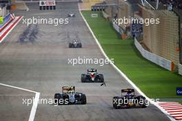 Max Verstappen (NLD) Scuderia Toro Rosso STR11 leads Sergio Perez (MEX) Sahara Force India F1 VJM09, as a car part flies up in front of Stoffel Vandoorne (BEL) McLaren MP4-31. 03.04.2016. Formula 1 World Championship, Rd 2, Bahrain Grand Prix, Sakhir, Bahrain, Race Day.