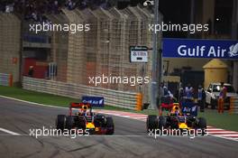 (L to R): Daniel Ricciardo (AUS) Red Bull Racing RB12 and Daniil Kvyat (RUS) Red Bull Racing RB12 battle for position. 03.04.2016. Formula 1 World Championship, Rd 2, Bahrain Grand Prix, Sakhir, Bahrain, Race Day.