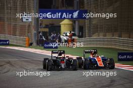 (L to R): Stoffel Vandoorne (BEL) McLaren MP4-31 and Pascal Wehrlein (GER) Manor Racing MRT05 battle for position. 03.04.2016. Formula 1 World Championship, Rd 2, Bahrain Grand Prix, Sakhir, Bahrain, Race Day.