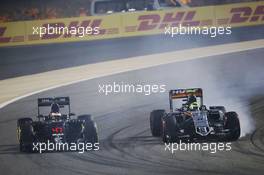 Stoffel Vandoorne (BEL) McLaren MP4-31 and Sergio Perez (MEX) Sahara Force India F1 VJM09 battle for position. 03.04.2016. Formula 1 World Championship, Rd 2, Bahrain Grand Prix, Sakhir, Bahrain, Race Day.