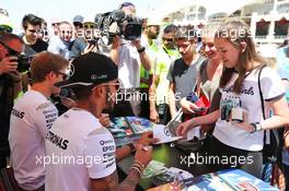 Lewis Hamilton (GBR) Mercedes AMG F1 and team mate Nico Rosberg (GER) Mercedes AMG F1 sign autographs for the fans. 02.04.2016. Formula 1 World Championship, Rd 2, Bahrain Grand Prix, Sakhir, Bahrain, Qualifying Day.
