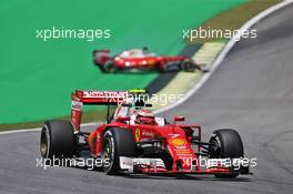 Kimi Raikkonen (FIN) Ferrari SF16-H as team mate Sebastian Vettel (GER) Ferrari SF16-H spins. 11.11.2016. Formula 1 World Championship, Rd 20, Brazilian Grand Prix, Sao Paulo, Brazil, Practice Day.