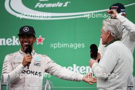 Race winner Lewis Hamilton (GBR) Mercedes AMG F1 celebrates on the podium with Michael Douglas (USA) Actor. 12.06.2016. Formula 1 World Championship, Rd 7, Canadian Grand Prix, Montreal, Canada, Race Day.