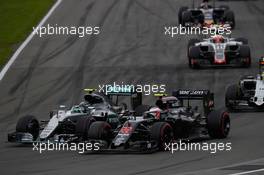 Nico Rosberg (GER) Mercedes AMG F1 W07 Hybrid and Jenson Button (GBR) McLaren MP4-31 battle for position. 12.06.2016. Formula 1 World Championship, Rd 7, Canadian Grand Prix, Montreal, Canada, Race Day.