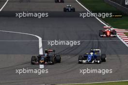 Carlos Sainz Jr (ESP) Scuderia Toro Rosso STR11 and Marcus Ericsson (SWE) Sauber C35 battle for position. 17.04.2016. Formula 1 World Championship, Rd 3, Chinese Grand Prix, Shanghai, China, Race Day.