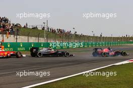 Carlos Sainz Jr (ESP) Scuderia Toro Rosso STR11 locks up under braking ahead of Fernando Alonso (ESP) McLaren MP4-31 and Sebastian Vettel (GER) Ferrari SF16-H. 17.04.2016. Formula 1 World Championship, Rd 3, Chinese Grand Prix, Shanghai, China, Race Day.