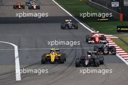 Jenson Button (GBR) McLaren MP4-31 and Jolyon Palmer (GBR) Renault Sport F1 Team RS16 battle for position. 17.04.2016. Formula 1 World Championship, Rd 3, Chinese Grand Prix, Shanghai, China, Race Day.