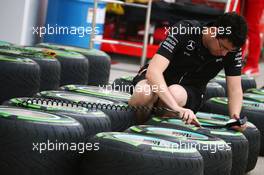 Mercedes AMG F1 mechanic with Pirelli tyres. 14.04.2016. Formula 1 World Championship, Rd 3, Chinese Grand Prix, Shanghai, China, Preparation Day.