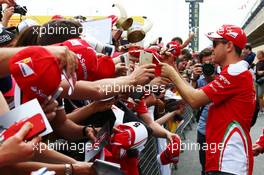 Sebastian Vettel (GER) Ferrari signs autographs for the fans. 12.05.2016. Formula 1 World Championship, Rd 5, Spanish Grand Prix, Barcelona, Spain, Preparation Day.