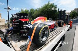 The damaged Red Bull Racing RB12 of Daniel Ricciardo (AUS) is recovered back to the pits on the back of a truck. 17.06.2016. Formula 1 World Championship, Rd 8, European Grand Prix, Baku Street Circuit, Azerbaijan, Practice Day.