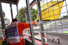 A marshal waves the yellow flag. 17.06.2016. Formula 1 World Championship, Rd 8, European Grand Prix, Baku Street Circuit, Azerbaijan, Practice Day.
