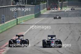 (L to R): Carlos Sainz Jr (ESP) Scuderia Toro Rosso STR11 and Fernando Alonso (ESP) McLaren MP4-31 battle for position. 19.06.2016. Formula 1 World Championship, Rd 8, European Grand Prix, Baku Street Circuit, Azerbaijan, Race Day.