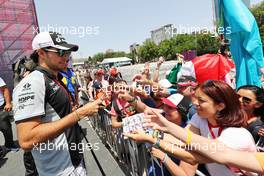 Sergio Perez (MEX) Sahara Force India F1 signs autographs for the fans. 18.06.2016. Formula 1 World Championship, Rd 8, European Grand Prix, Baku Street Circuit, Azerbaijan, Qualifying Day.