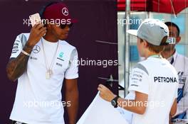 Lewis Hamilton (GBR) Mercedes AMG F1 with a young fan on the drivers parade. 19.06.2016. Formula 1 World Championship, Rd 8, European Grand Prix, Baku Street Circuit, Azerbaijan, Race Day.