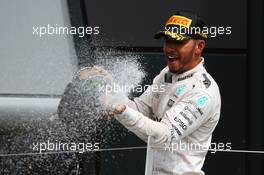 Race winner Lewis Hamilton (GBR) Mercedes AMG F1 celebrates with the champagne on the podium. 10.07.2016. Formula 1 World Championship, Rd 10, British Grand Prix, Silverstone, England, Race Day.