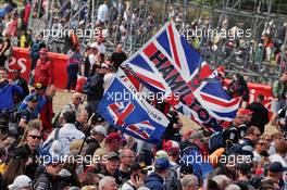 Fans at the podium with flags for Lewis Hamilton (GBR) Mercedes AMG F1. 10.07.2016. Formula 1 World Championship, Rd 10, British Grand Prix, Silverstone, England, Race Day.