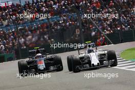 Valtteri Bottas (FIN) Williams FW38 leads Jenson Button (GBR) McLaren MP4-31. 10.07.2016. Formula 1 World Championship, Rd 10, British Grand Prix, Silverstone, England, Race Day.