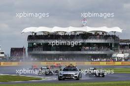 Lewis Hamilton (GBR) Mercedes AMG F1 W07 Hybrid leads behind the FIA Safety Car. 10.07.2016. Formula 1 World Championship, Rd 10, British Grand Prix, Silverstone, England, Race Day.