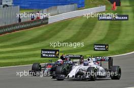 Valtteri Bottas (FIN) Williams FW38 and Jenson Button (GBR) McLaren MP4-31 battle for position. 10.07.2016. Formula 1 World Championship, Rd 10, British Grand Prix, Silverstone, England, Race Day.
