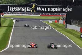 Sebastian Vettel (GER) Ferrari SF16-H and Jenson Button (GBR) McLaren MP4-31 battle for position. 10.07.2016. Formula 1 World Championship, Rd 10, British Grand Prix, Silverstone, England, Race Day.