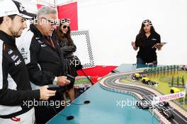 Dr. Vijay Mallya (IND) Sahara Force India F1 Team Owner and Sergio Perez (MEX) Sahara Force India F1 play Scalextric at the Sahara Force India F1 Team Fan Zone at Woodlands Campsite. 09.07.2016. Formula 1 World Championship, Rd 10, British Grand Prix, Silverstone, England, Qualifying Day.