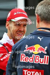 (L to R): Sebastian Vettel (GER) Ferrari with Paul Monaghan (GBR) Red Bull Racing Chief Engineer. 07.07.2016. Formula 1 World Championship, Rd 10, British Grand Prix, Silverstone, England, Preparation Day.