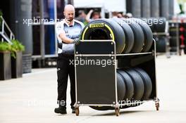 A McLaren mechanic with Pirelli tyres. 07.07.2016. Formula 1 World Championship, Rd 10, British Grand Prix, Silverstone, England, Preparation Day.