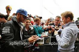 Lewis Hamilton (GBR) Mercedes AMG F1 and team mate Nico Rosberg (GER) Mercedes AMG F1 sign autographs for the fans. 07.07.2016. Formula 1 World Championship, Rd 10, British Grand Prix, Silverstone, England, Preparation Day.
