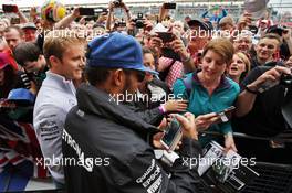 Lewis Hamilton (GBR) Mercedes AMG F1 and team mate Nico Rosberg (GER) Mercedes AMG F1 sign autographs for the fans. 07.07.2016. Formula 1 World Championship, Rd 10, British Grand Prix, Silverstone, England, Preparation Day.